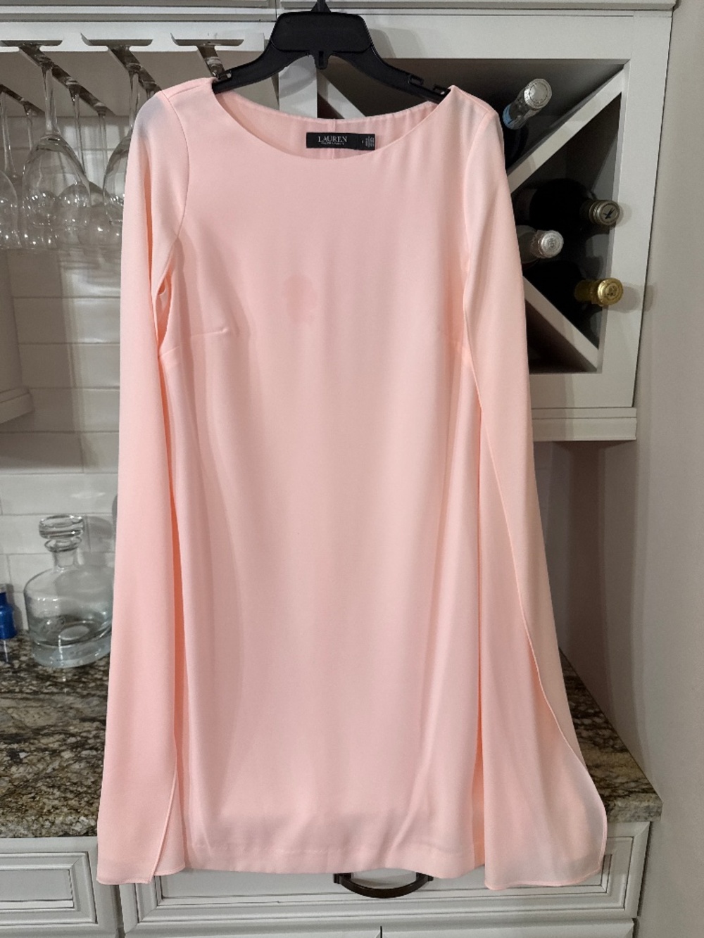 Short, light pink caped dress.